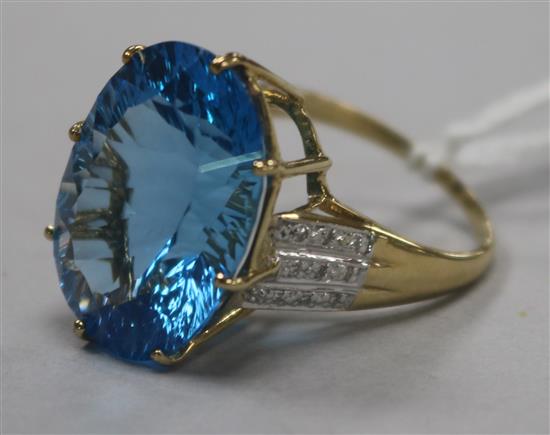 A 9ct gold and fancy cut blue topaz dress ring with diamond set shoulders, size Q.
